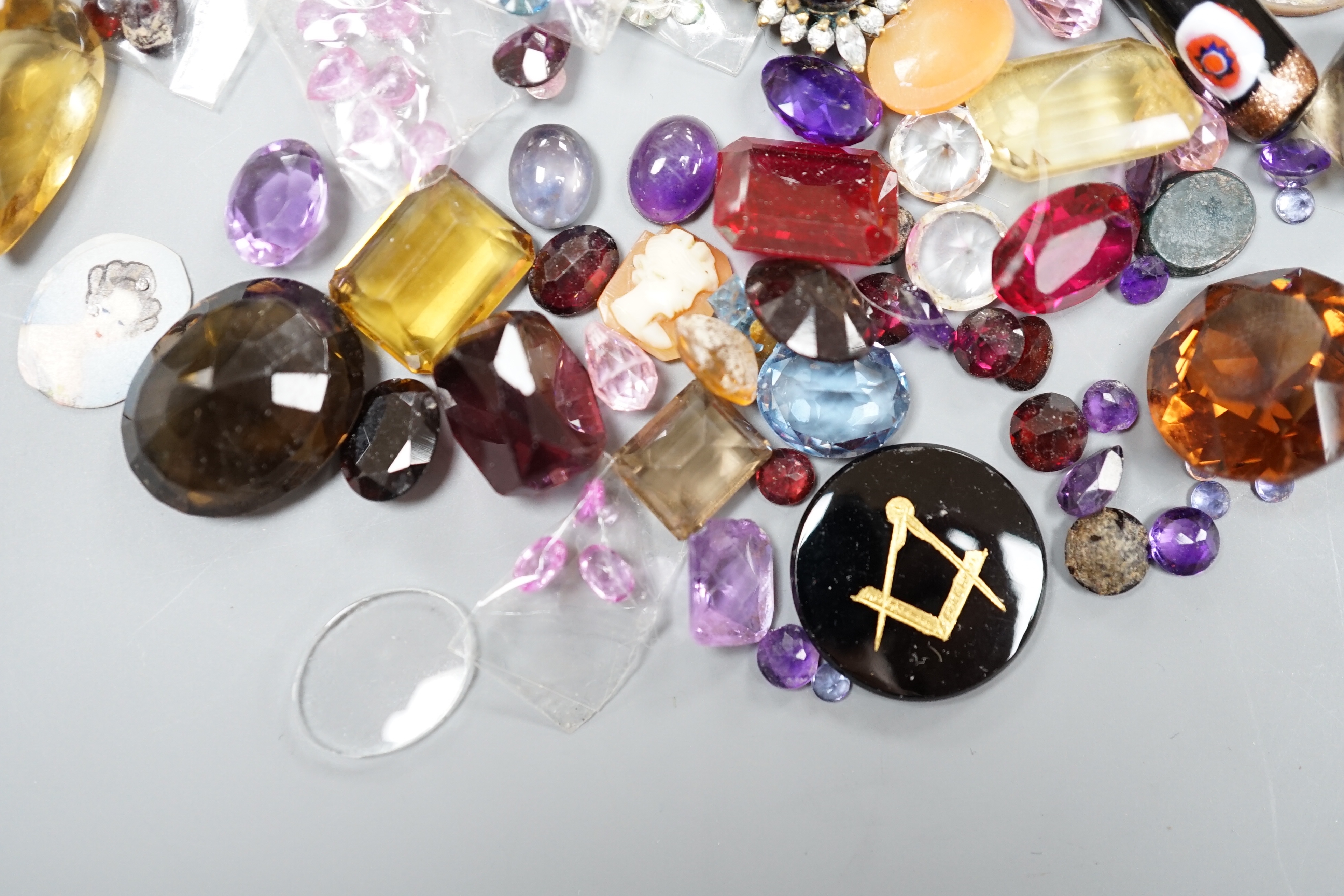 A quantity of assorted unmounted cut gemstones including small diamonds and other minor jewellery.